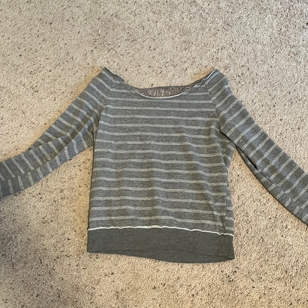 A grey long sleeve size Medium